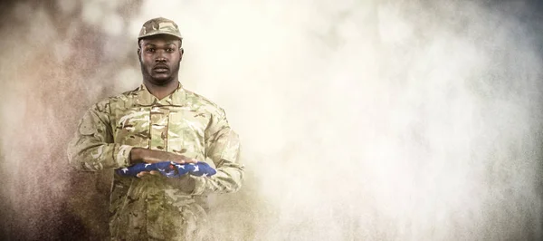 Soldier holding american flag — Stock Photo, Image