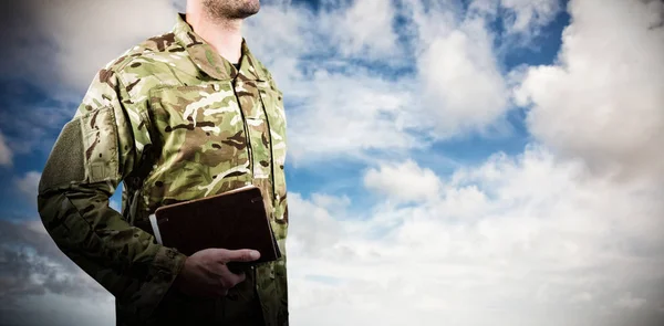 Soldier holding books while standing — Stock Photo, Image