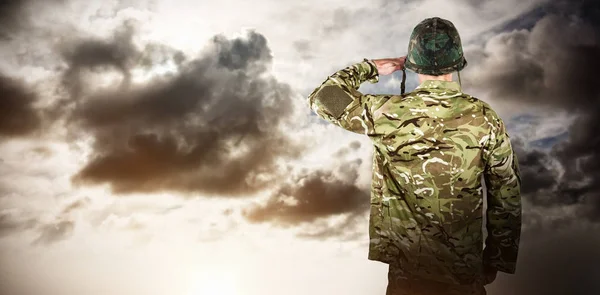 Rear view of military soldier saluting — Stock Photo, Image