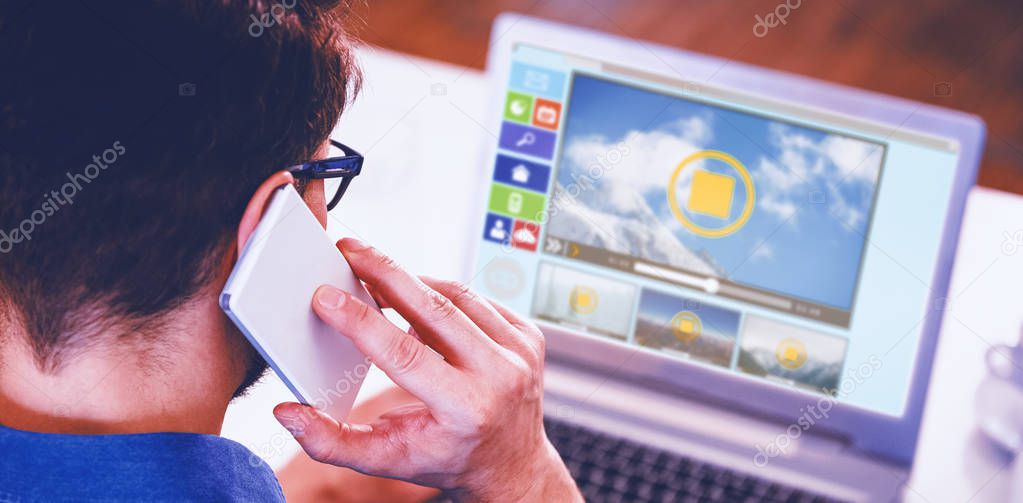 man using mobile phone and laptop