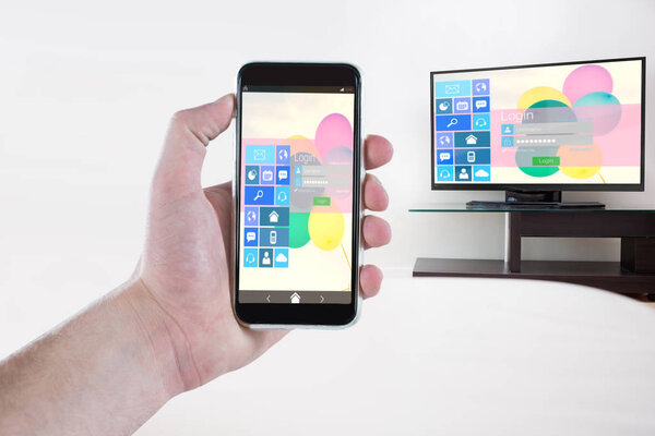 Composite image of cropped hand holding mobile phone