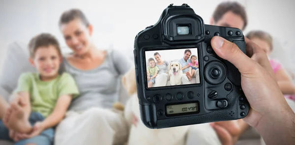 Fotógrafo celebración de la cámara con feliz familia con perro en la pantalla — Foto de Stock