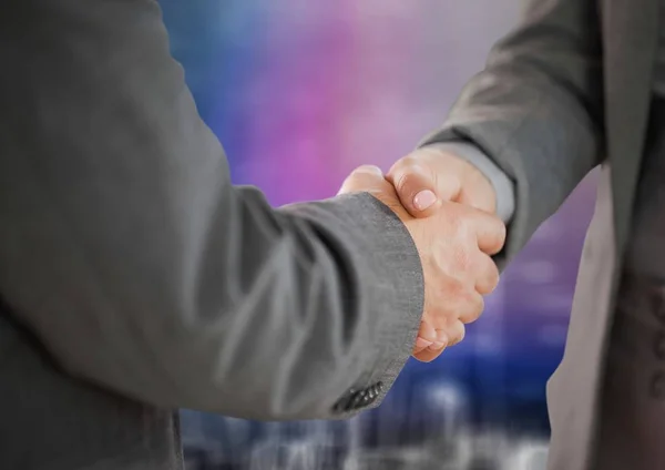 Business handshake against wall — Stock Photo, Image