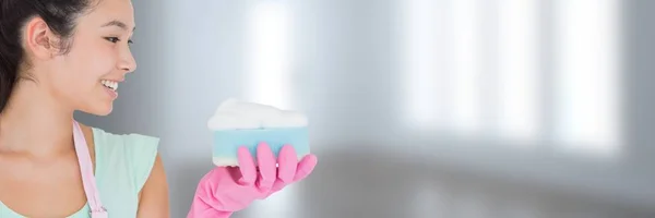 Cleaner holding scrubber sponge with bright background — Stock Photo, Image