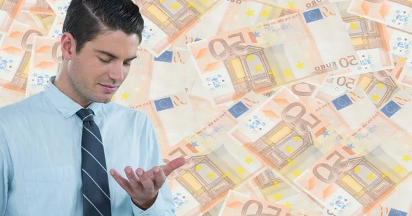 Business man looking at hand against money backdrop — Stock Photo, Image