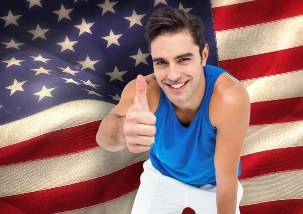 Sporty man thumb up against american flag