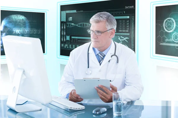 Composite 3d image of male doctor holding clipboard while looking at computer monitor Stock Photo