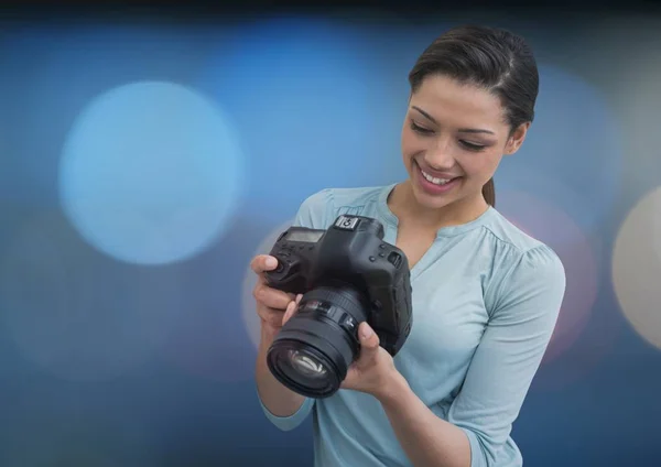 Photographer smiling looking the photos — Stock Photo, Image