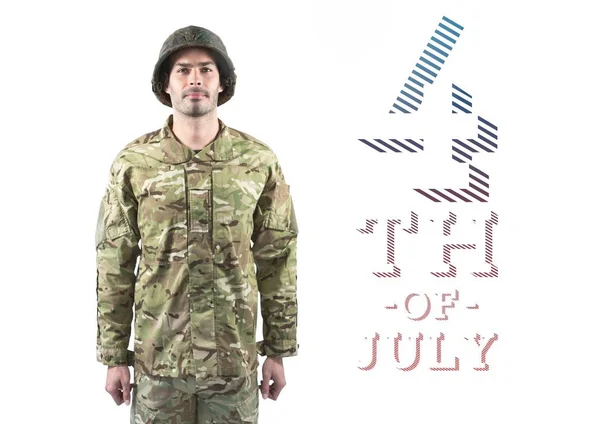 Proud soldier standing against 4th of July — Stock Photo, Image