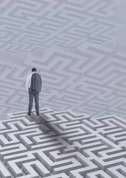 Man standing on a 3D maze against background with mazes