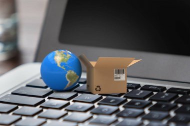 Küre yakın karşı karton kutu tarafından yukarıya laptop