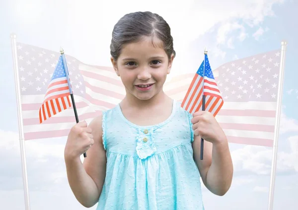 Chica sosteniendo banderas americanas — Foto de Stock