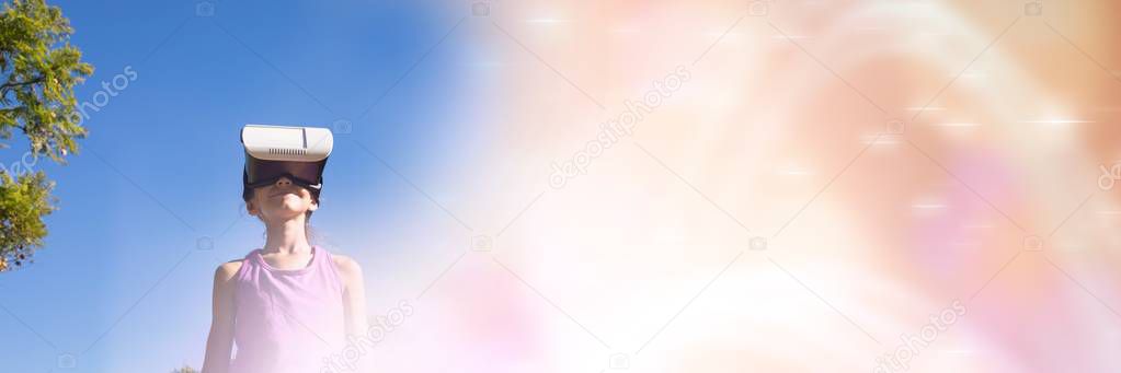 Low angle of girl with virtual reality headset against sky with blurry peach transition