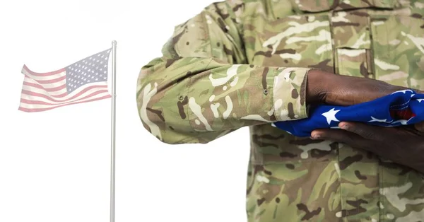 Soldier holding the american flag — Stock Photo, Image