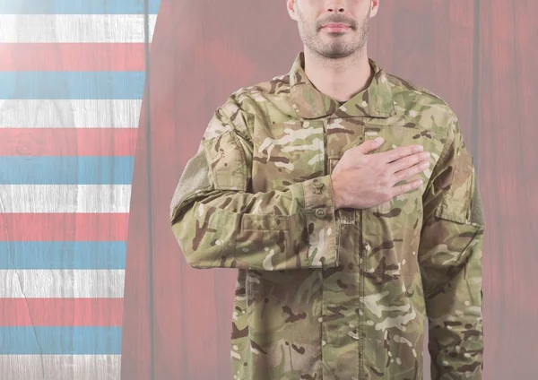 Soldier putting his hand on his heart for independence day — Stock Photo, Image