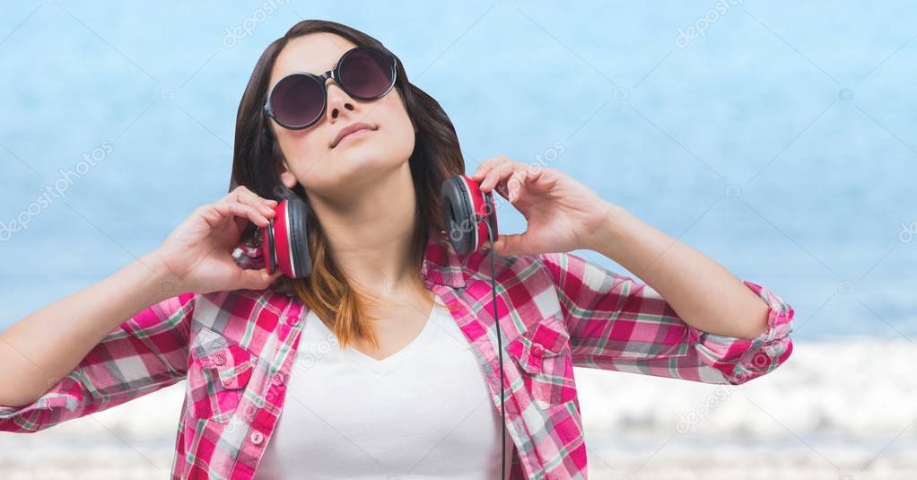 Woman with headphones soaking up sun