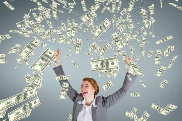 Excited business woman with money rain against blue background — Stock Photo, Image