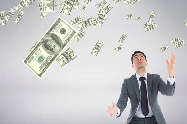 Hombre de negocios mirando el dinero lluvia sobre fondo blanco — Foto de Stock