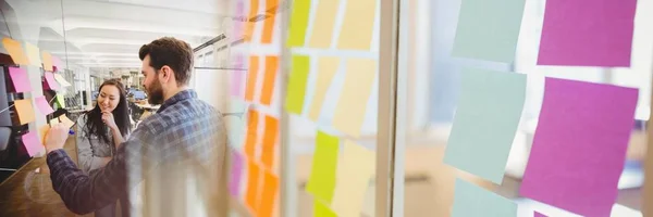 Millennial team writing on sticky notes with sticky note transition — Stock Photo, Image