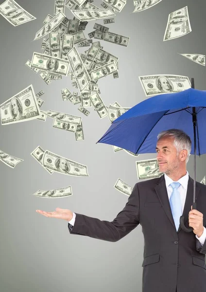 Business man under umbrella looking at money rain against grey background — Stock Photo, Image