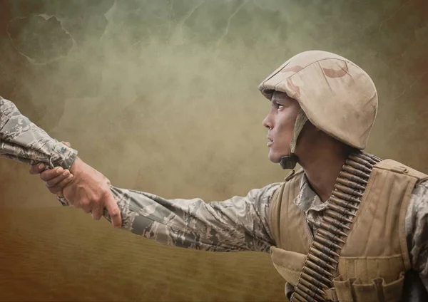 Soldier men giving hands against brown background — Stock Photo, Image
