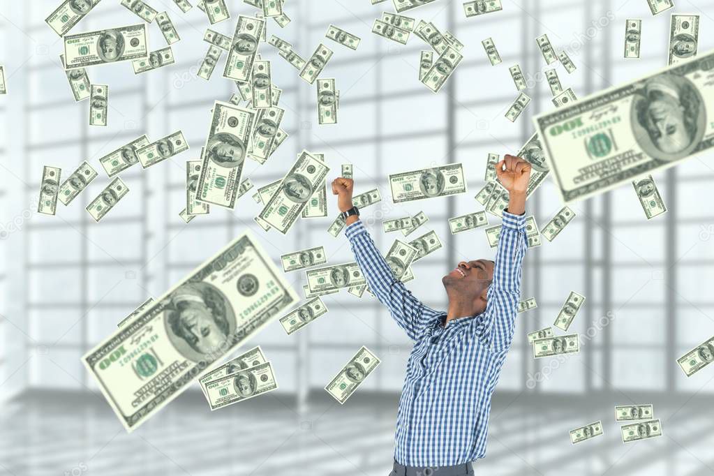 Excited business man looking at money rain against white background