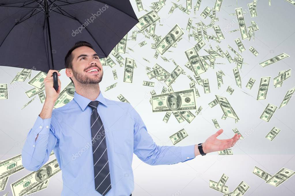 Happy business man under umbrella