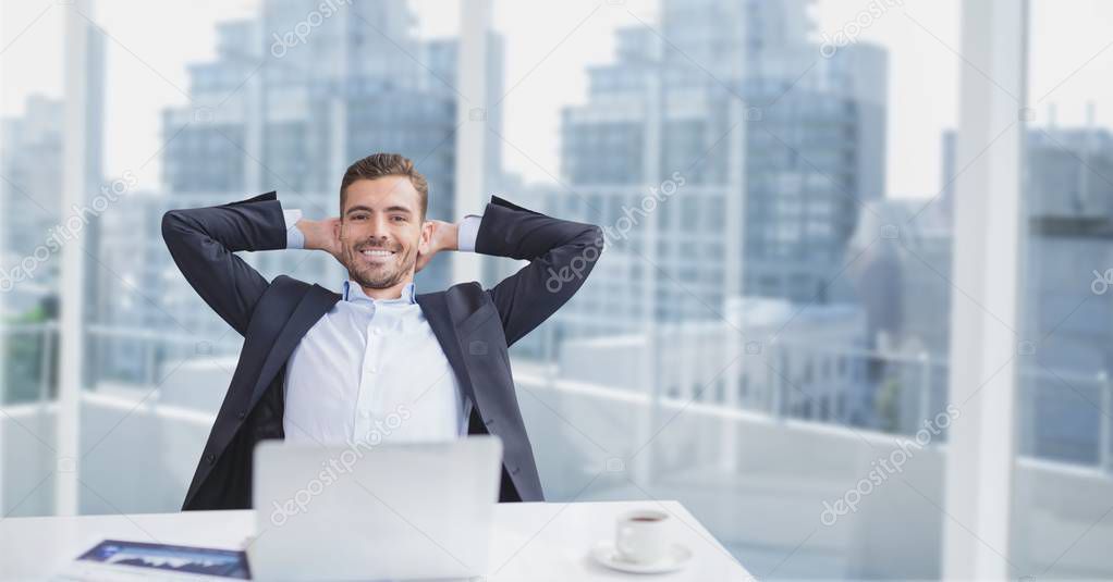 Happy business man sitting at desk