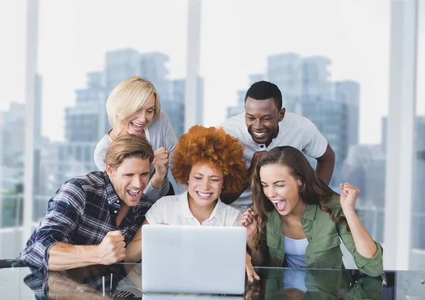 Excited business people at a desk — Stock Photo, Image