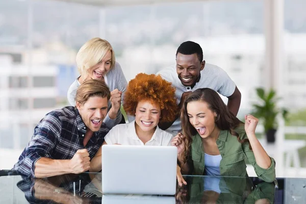 Excited business people at a desk — Stock Photo, Image