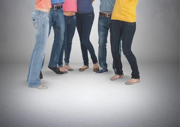Group of students standing in front of blank grey background — Stock Photo, Image