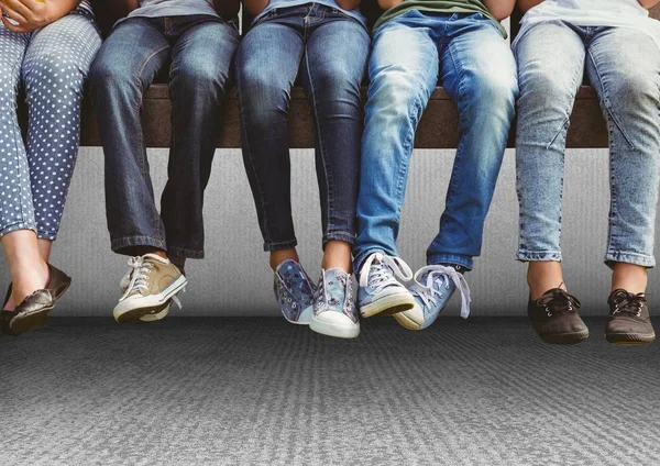 Group of human legs sitting on bench