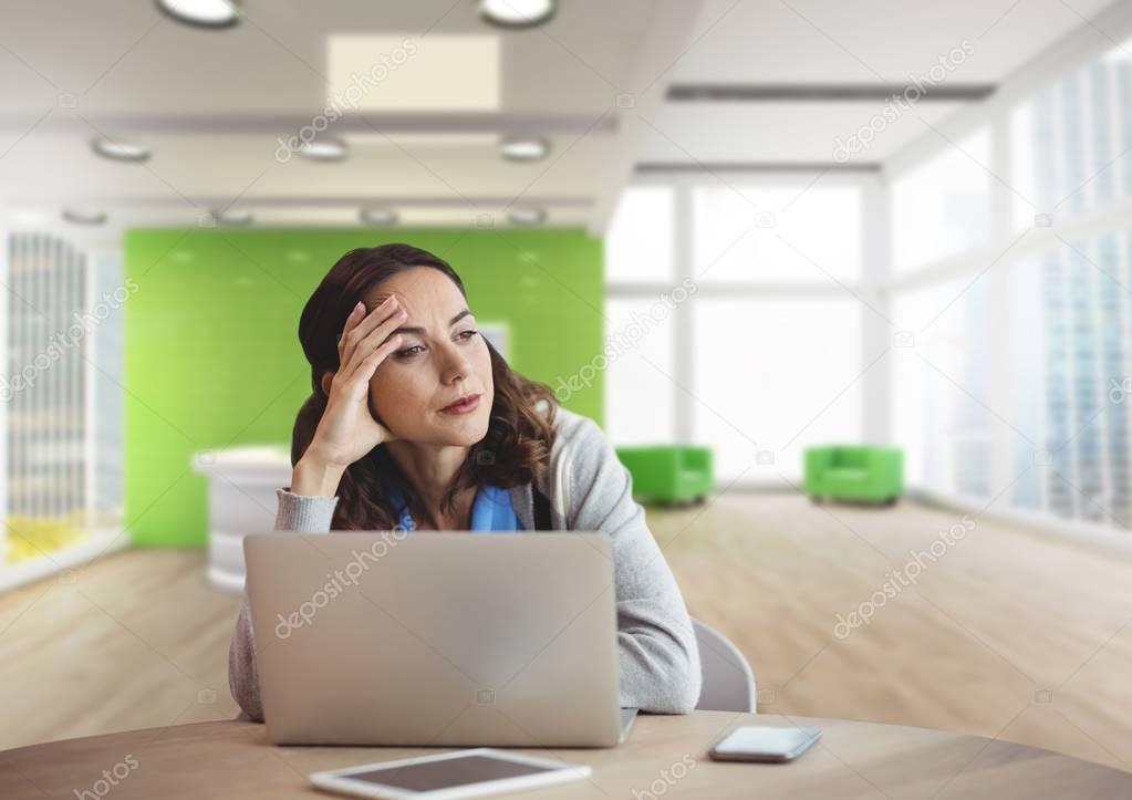 Worried business woman using a computer