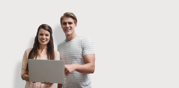 couple posing with laptop