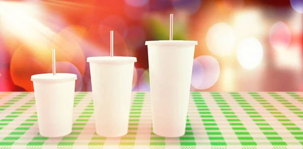 White cups on green checker surface — Stock Photo, Image