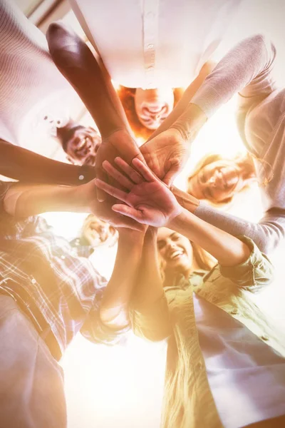 Smiling people stacking hands — Stock Photo, Image