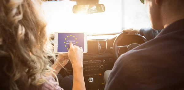 Pareja mirando la tableta en el coche — Foto de Stock