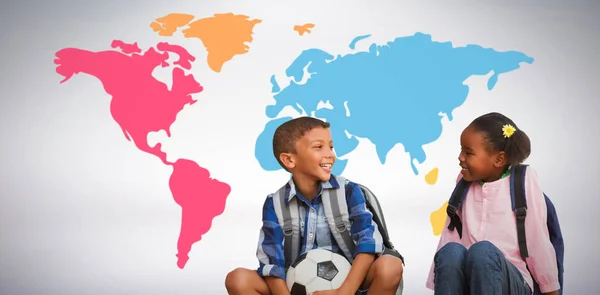 Niño con amigo sosteniendo pelota de fútbol — Foto de Stock