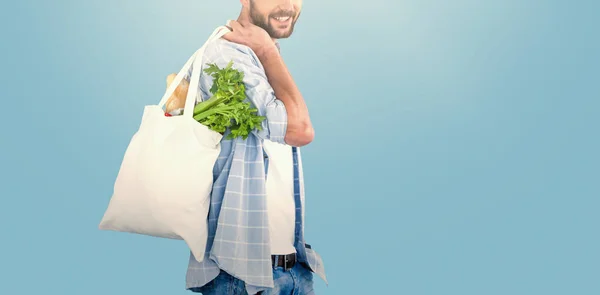 Mannen bär grönsaker i Shoppingbag — Stockfoto