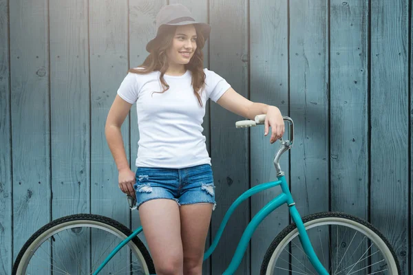 Smiling woman leaning on bicycle — Stock Photo, Image