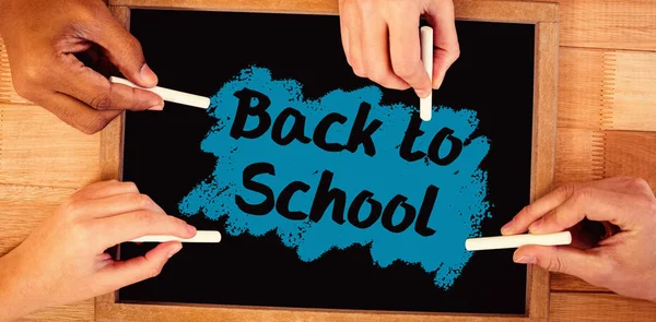 Hands writing on chalkboard — Stock Photo, Image