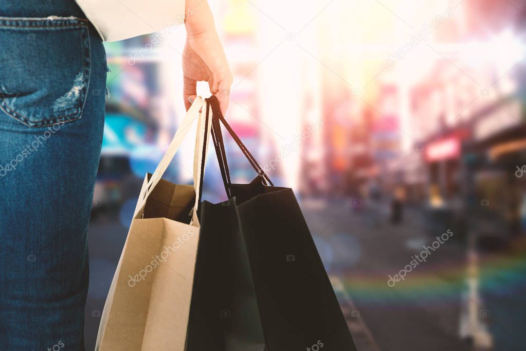 brunette woman holding bags 