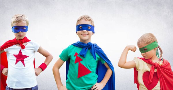 Superhero kids with grey wall