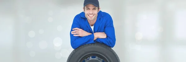Happy mechanic man on wheel — Stock Photo, Image