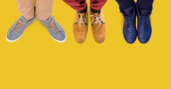 Feet and shoes with yellow background — Stock Photo, Image