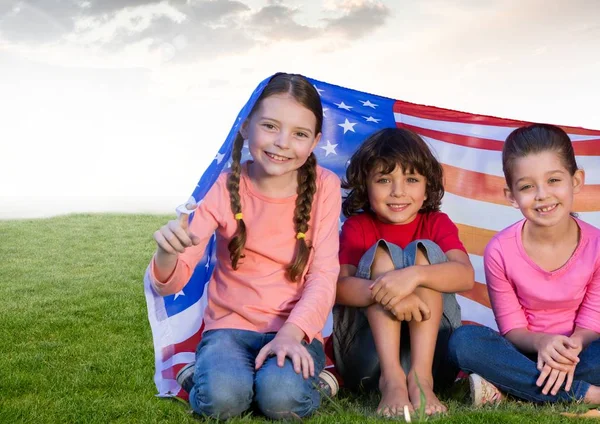 Kids sitting under american flag — Stock Photo, Image