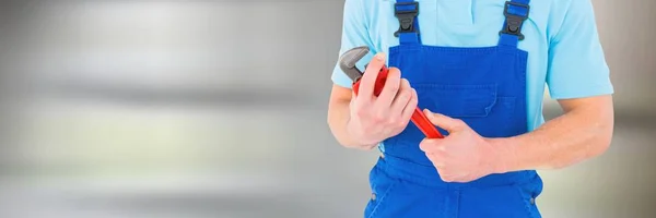 Plumber man holding wrench — Stock Photo, Image