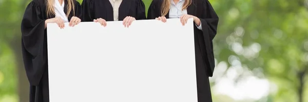 Graduated people holding blank card