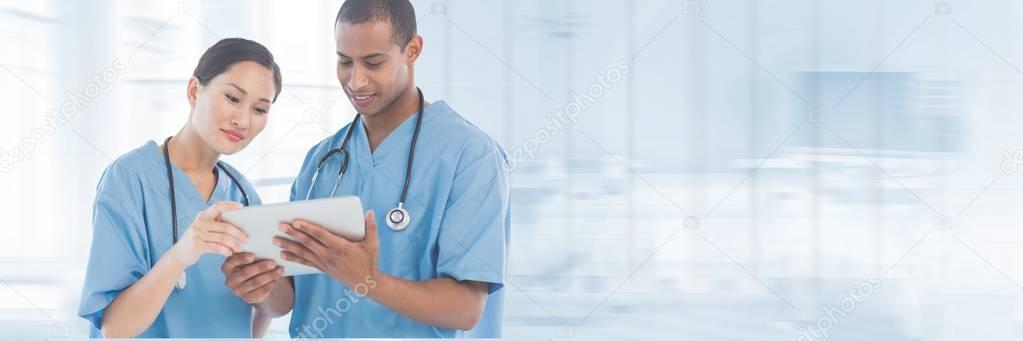 Doctors looking at tablet 