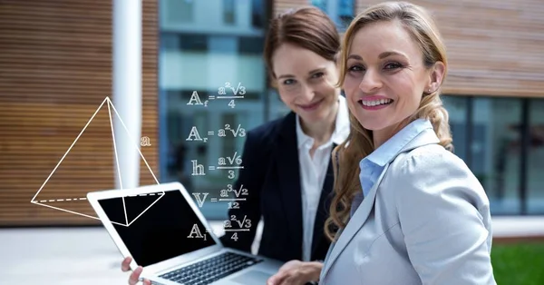 Businesswomen planning strategies on laptop — Stock Photo, Image